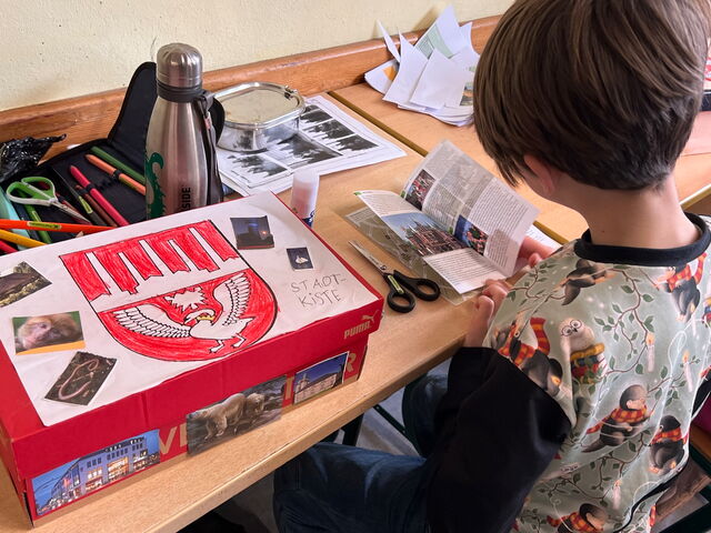 Schülerinnen und Schüler beim Zeichnen von Wappen
